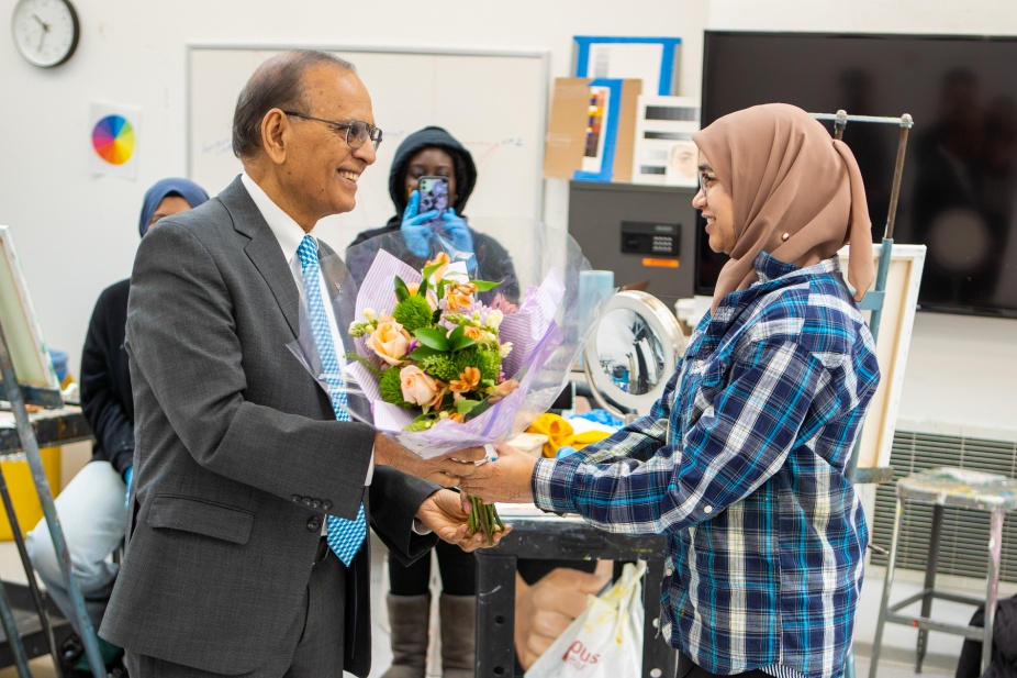 Satish Tripathi surprised student Samiha Islam (right) in her paint class at the CFA in April 2023. Samiha Islam won the Harry S. Truman Scholarship. Photographer: Douglas Levere. 