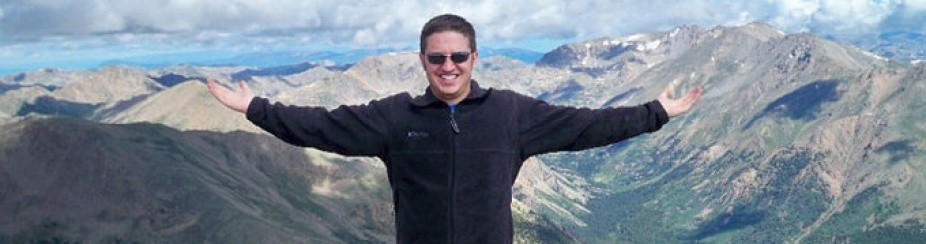 Bradley Cheetham standing in front of a mountain. 