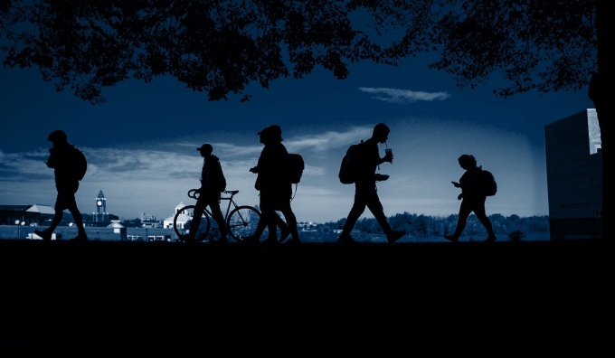 Student silouettes on walking across campus.