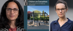 Two women in glasses looking at the camera, between them, a book cover with a photo of the outdoors. 