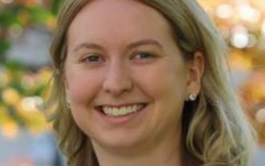 Woman with blonde hair, smiling at the camera. 