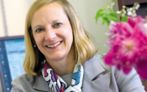 Woman with blonde hair, smiling at the camera. 