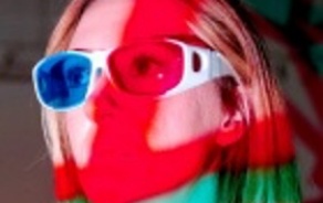 Woman wearing gasses obscured by red light. 