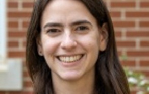 Woman with dark hair smiling at the camera. 
