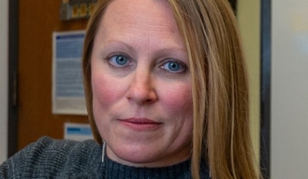 Photo shows a women looking at the camera. 