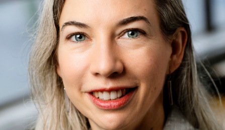 A woman with blonde hair, smiling at the camera. 