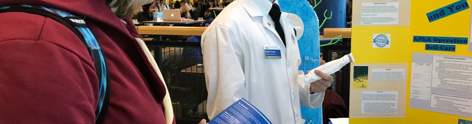 UB Pharmacy student speaks with UB student. 