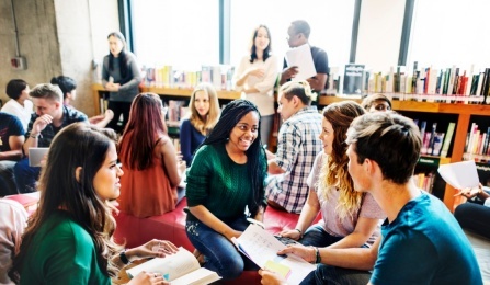 Conversation taking place among people at a table. 