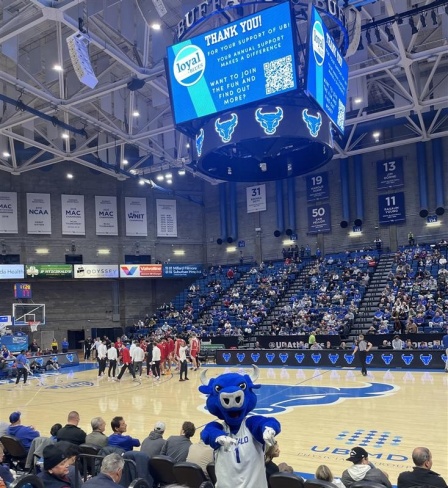 Victor E. Bull is exciting the crowd at a UB Men's Basketball game as a thank you to donors appears on the scoreboard.
