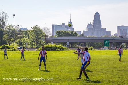 Men playing soccer at World Refugee Day.