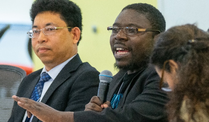 Theo Herman speaking at the 6th Annual Western New York Refugee Health Summit. 