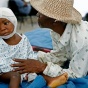 Comforting the injured in Haiti Earthquake, Adriana Zehbrauskas-Polaris, 2010, Unmodified. 