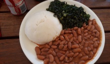 "A typical Zimbabwean lunch for vegetarians. It includes sadza (thick maize flour porridge that is the staple food in Zimbabwe), greens (I think this was pumpkin leaves or collard greens) and stewed beans. Zimbabweans LOVE meat, so it's not an accurate representation of what a non-vegetarian would eat. But it was yummy!". 