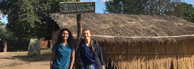 Korinne and Jennifer next to a wound care site. 