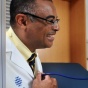 UBMD doctor with a pediatric patient, allowing her to use his stethescope and listen to his heart. 
