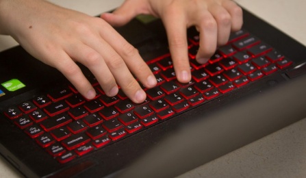 Hands typing on a keyboard. 