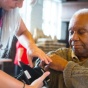 Healthcare working taking blood pressure of a older patient. 