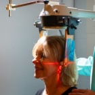 A female health care worker conducting a scan on a female patient. 
