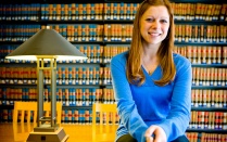 A female student in the UB Law Library. 