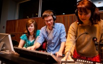 An image of students operating a theatre control board. 