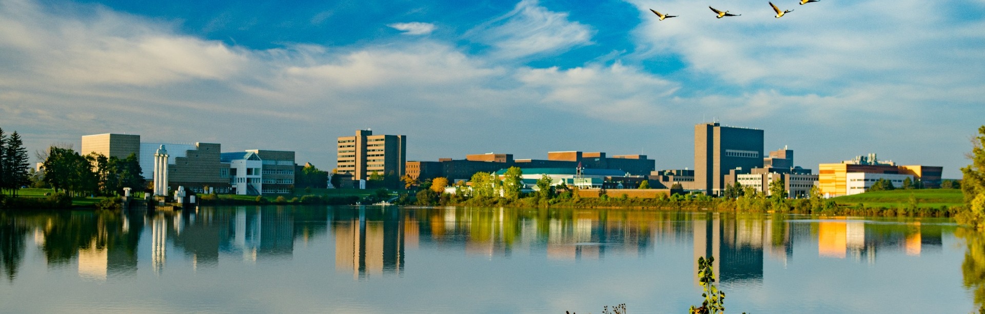 North campus exterior fall landscape images over Lake LaSalle. Photographer: Douglas Levere. 