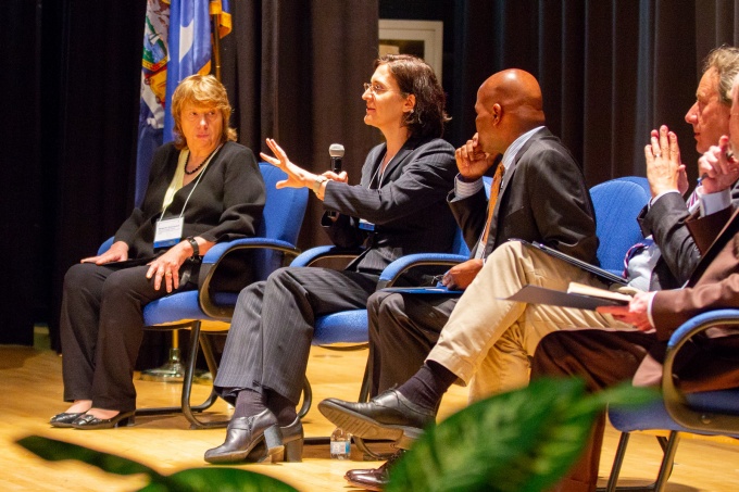 Inclusive Excellence Summit keynote panel featuring SUNY Distinguished Professor Margarita Dubocovich, Director of the Office of Equity, Diversity and Inclusion Sharon Nolan-Weiss (who is speaking), Vice Provost for Enrollment Management Lee Melvin, Anthropology Professor Peter Biehl, and Architecture and Planning Dean Robert Shibley. 