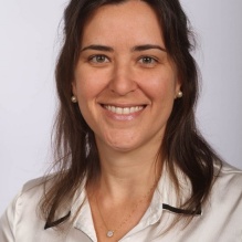 Ligi Schmitd smiling infront solid background. 