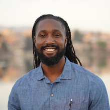 Clifton E. Sorrell III smiling with blue gray shirt and outside background. 