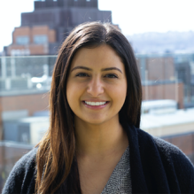 Sarah Alamdari smiling with building in the background. 