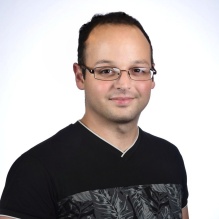 Alberto Valido smiling with black t-shirt and clear background. 