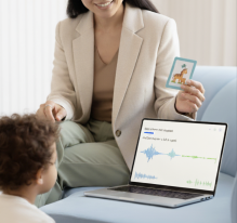 SATE - female clinician holding a picture card up to assess a child's development. 