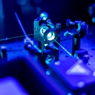 Laser reflects on an optic table in a quantum laboratory. 