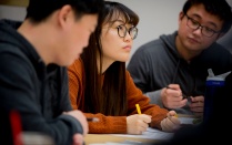 Three students in a lecture. 