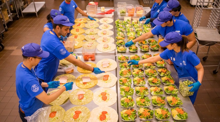 Students preparing food with Campus Dining and Shops. 
