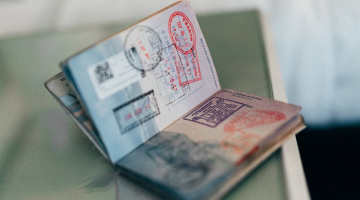 Open passport with travel stamps. 
