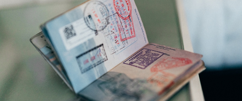 Open passport with travel stamps. 
