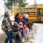 Group of children getting off a school bus. 
