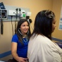 Medical practioner performing check-up on woman. 