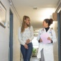 Student and medical practioner talking in a hallway. 