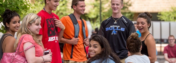 students outside a residence hall. 
