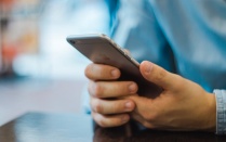 Male hands holding a phone. 