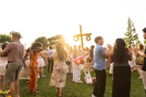 Photo from a Midsummer Celebration in a park-like setting wiht a Mayple inthe background.
