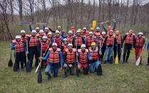Group of 35 to 40 student psoing for a gorup picture wearing rafting gear. 