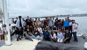 A group of students standing on the Moondance Catamaran.