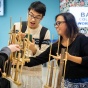 Students try out the angklung, an Indonesian musical instrument, as part of International Education Week. 