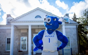 Bull mascot posing in front of Beck Hall. 