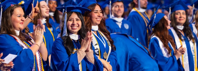 Graduate smiling at camera. 