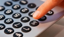 Finger Pressing Button on Calculator --- Image by &copy; Royalty-Free/Corbis. 