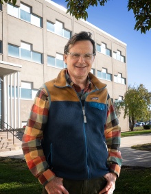 Michael J. Oldani, PhD, standing in front of a building on South Campus. 