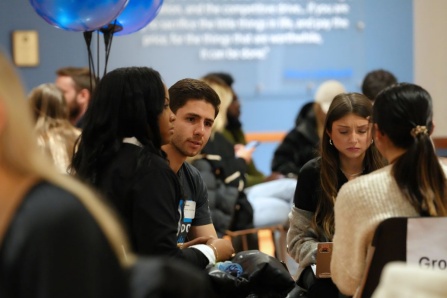 Students gathered in a group talking amongst themselves. 